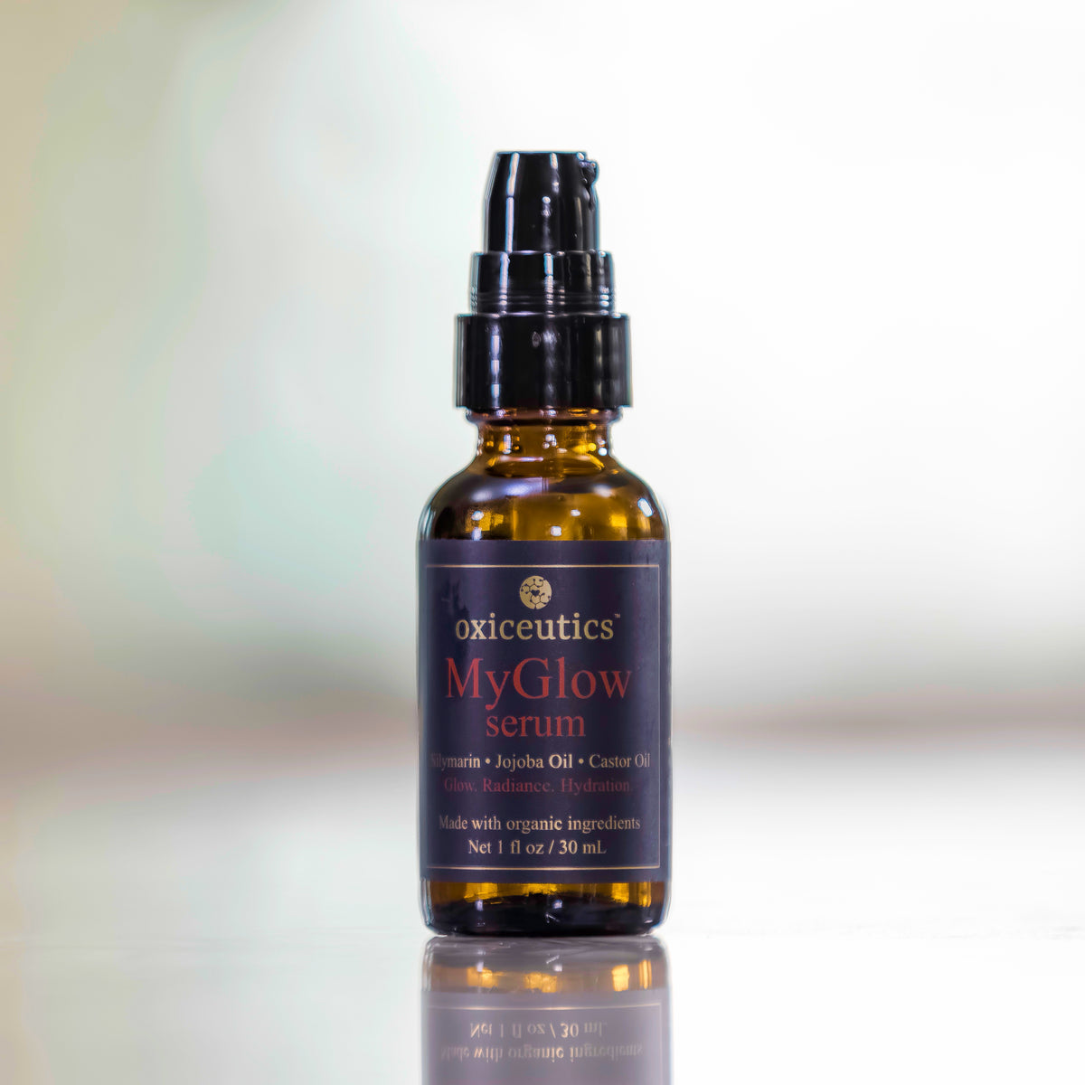 MyGlow serum bottle on a glossy surface